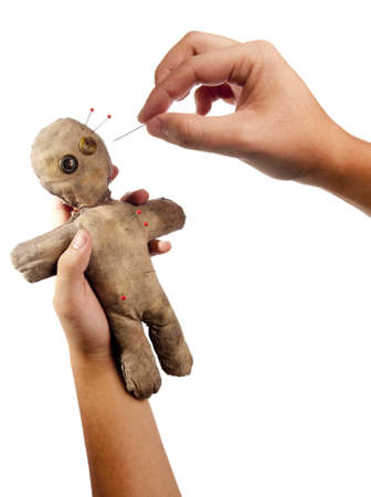 photo of hands holding creepy voodoo doll isolated on whiteの写真素材
