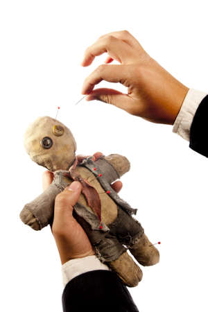businessman making harm to coworker via voodoo on whiteの写真素材