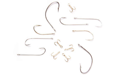 assorted fishing hooks isolated on whiteの写真素材