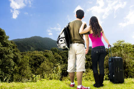 photo of beautiful Couple looking afar from the top of a mountainの写真素材
