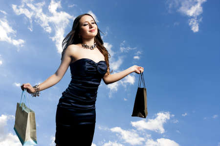 young and beautiful woman with shopping bagsの写真素材