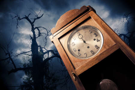 dark antique clock at Halloween nightの写真素材