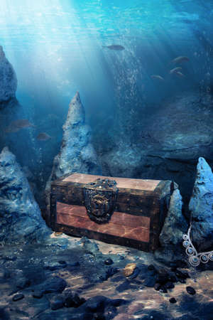 photo of wooden treasure chest submerged underwater with light raysの写真素材