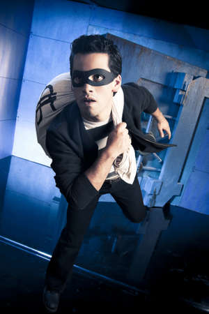 thief running out of a bank vault, low-key photoの写真素材