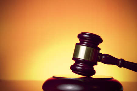 judge gavel on orange backgroundの写真素材