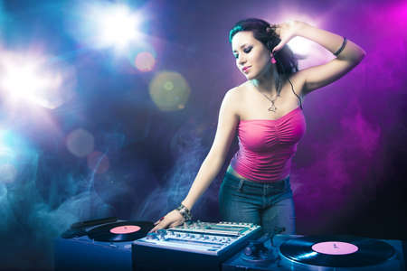 Beautiful DJ girl with bright lightsの写真素材