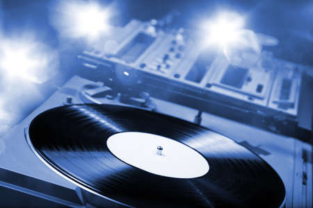 DJ mixer table with bright lightsの写真素材