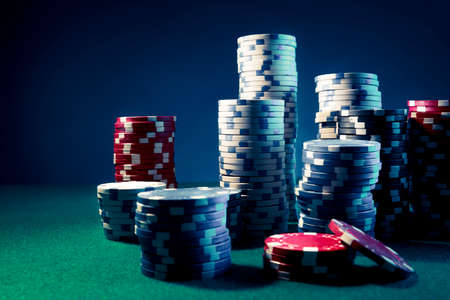 Poker Chips on a gaming table with dramatic lightingの写真素材