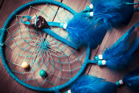 Dreamcatcher on a wood floorの写真素材