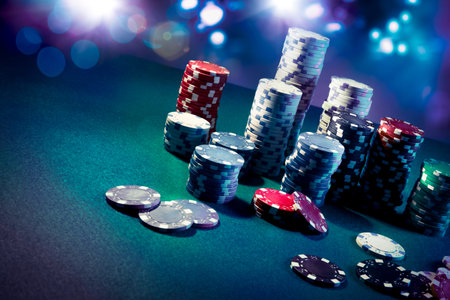 Poker Chips on a gaming table with dramatic lighting