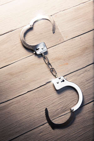 Open handcuffs, liberty concept on a wooden backgroundの写真素材