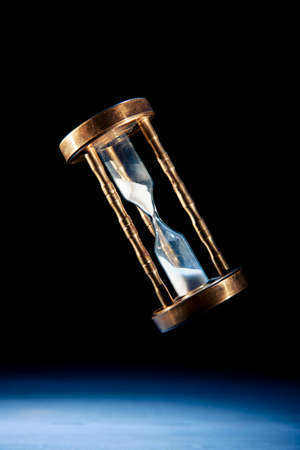 dramatic lit image of hourglass, time conceptの写真素材