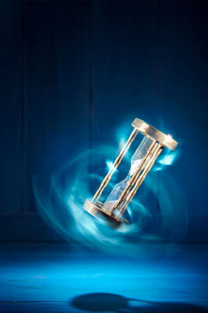 dramatic lit image of hourglass, time conceptの写真素材