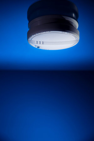 smoke detector on a blue backgroundの写真素材