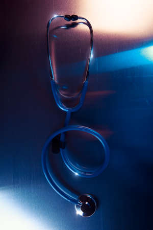 Medical Stethoscope on a metalic background and dramatic lightingの写真素材