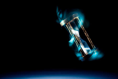 dramatic lit image of hourglass, time conceptの写真素材