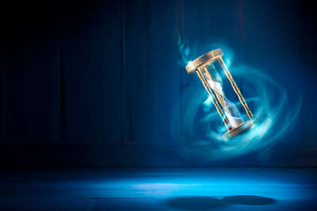 dramatic lit image of hourglass, time conceptの写真素材