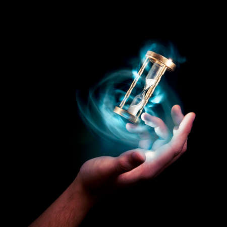 dramatic lit image of hourglass, time conceptの写真素材