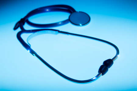 Medical Stethoscope on a blue background and dramatic lightingの写真素材