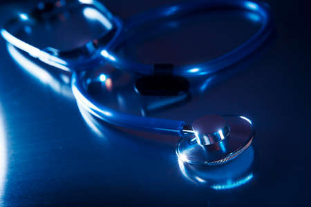 Medical Stethoscope on a metalic background and dramatic lightingの写真素材