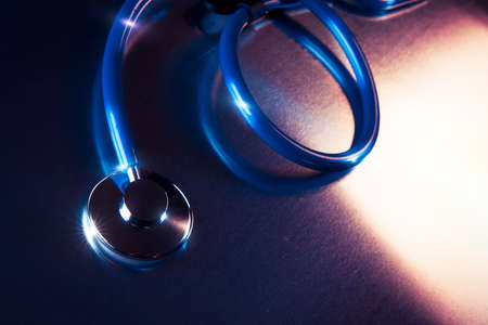 Medical Stethoscope on a metalic background and dramatic lightingの写真素材