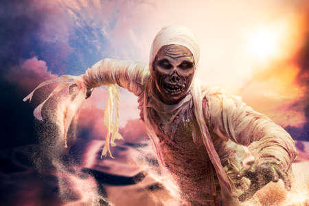 Scary Halloween mummy in hot desert with dramatic lightingの写真素材