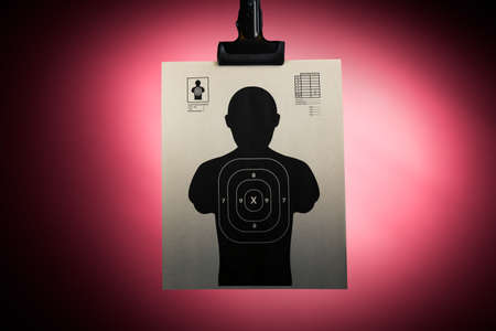 Shooting target hanging on a red backgroundの写真素材