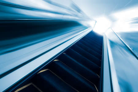 Empty escalator going up with motion blurの写真素材