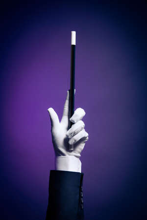 Magician hand with magic wandの写真素材