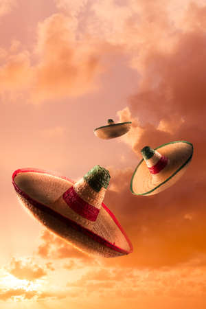 Mexican sombreros in a dramatic orange skyの写真素材