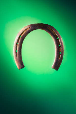 Horse shoe on a green backgroundの写真素材