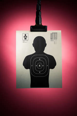 Shooting target hanging on a red backgroundの写真素材
