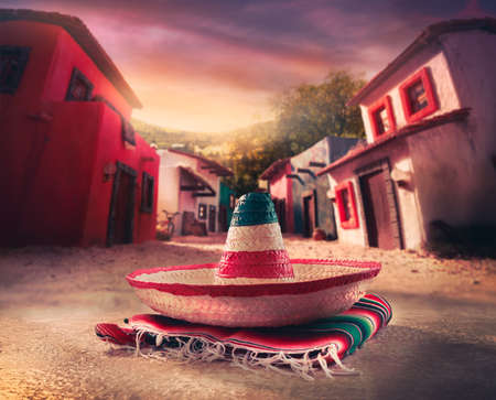 Mexican hat "sombrero" on a "serape" in a mexican town at sunsetの写真素材