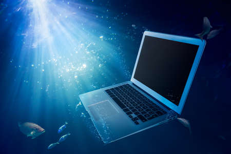 laptop on water/ damaged computerの写真素材