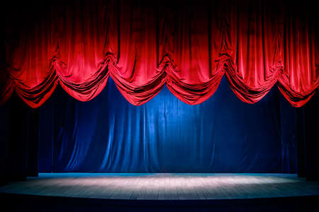 Theater curtain and stage with dramatic lightingの写真素材