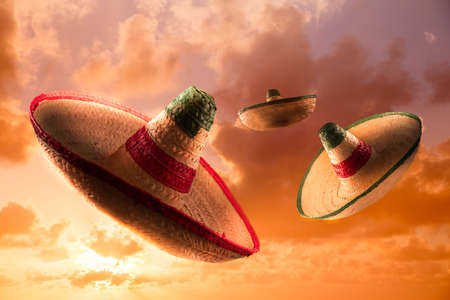 Mexican sombreros in a dramatic orange skyの写真素材