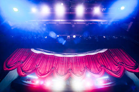 Theater curtain and stage with dramatic lightingの写真素材