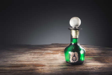 high contrast image of a poison bottle on a wooden surfaceの写真素材