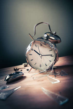 destroyed alarm clock on a wooden backgroundの写真素材