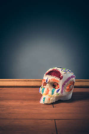 High contrast image of sugar skull used for "dia de los muertos" celebration in a grey backgroundの写真素材