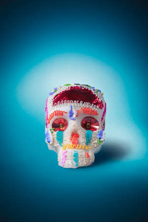 High contrast image of sugar skull used for "dia de los muertos" celebration in a blue backgroundの写真素材