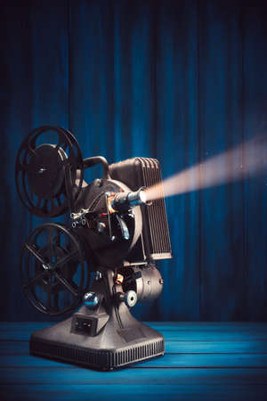 film projector on a wooden background with dramatic lighting and selective focusの写真素材