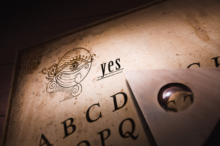 Talking board and planchette used on seances for communicating with the dead, high contrast image