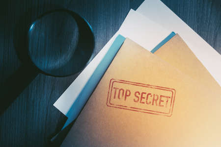 Private investigator desk with top secret envelopesの写真素材