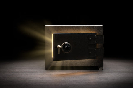Steel money bank safe on a dark background / dramatic lit image