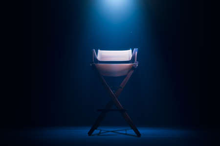 Back of a vintage director chair on a smokey background / high contrast imageの写真素材