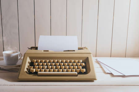 Vintage typewriter machine with accesories on a wood deskの写真素材