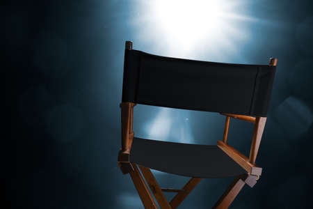 Back of a vintage director chair on a smokey background / high contrast imageの写真素材