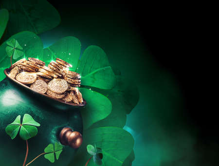 Saint Patricks day background with gold pot and four leaf clovers on a dark background / high contrast imageの写真素材
