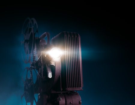Movie projector on a dark background with light beam / high contrast image